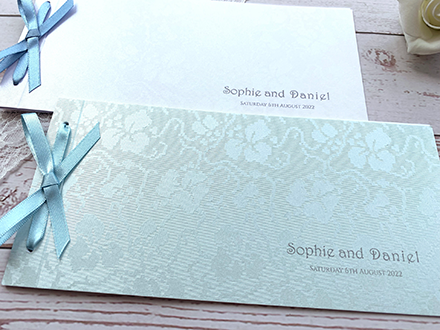 Close up of embossed lace pattern on broderie cheque books
